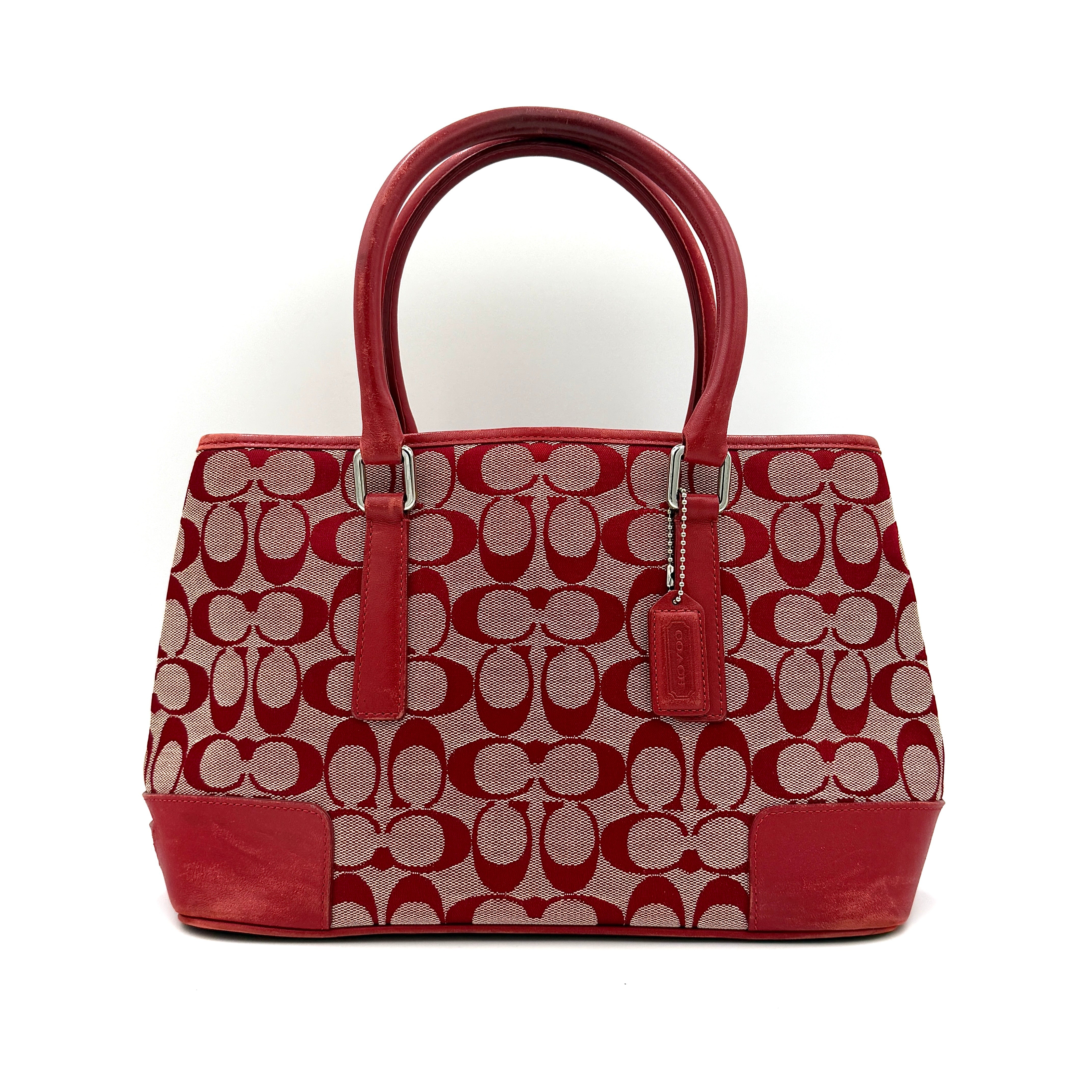 Coach Signature Canvas Handbag featuring a bold red color with iconic logo pattern, spacious interior, and dual handle design.