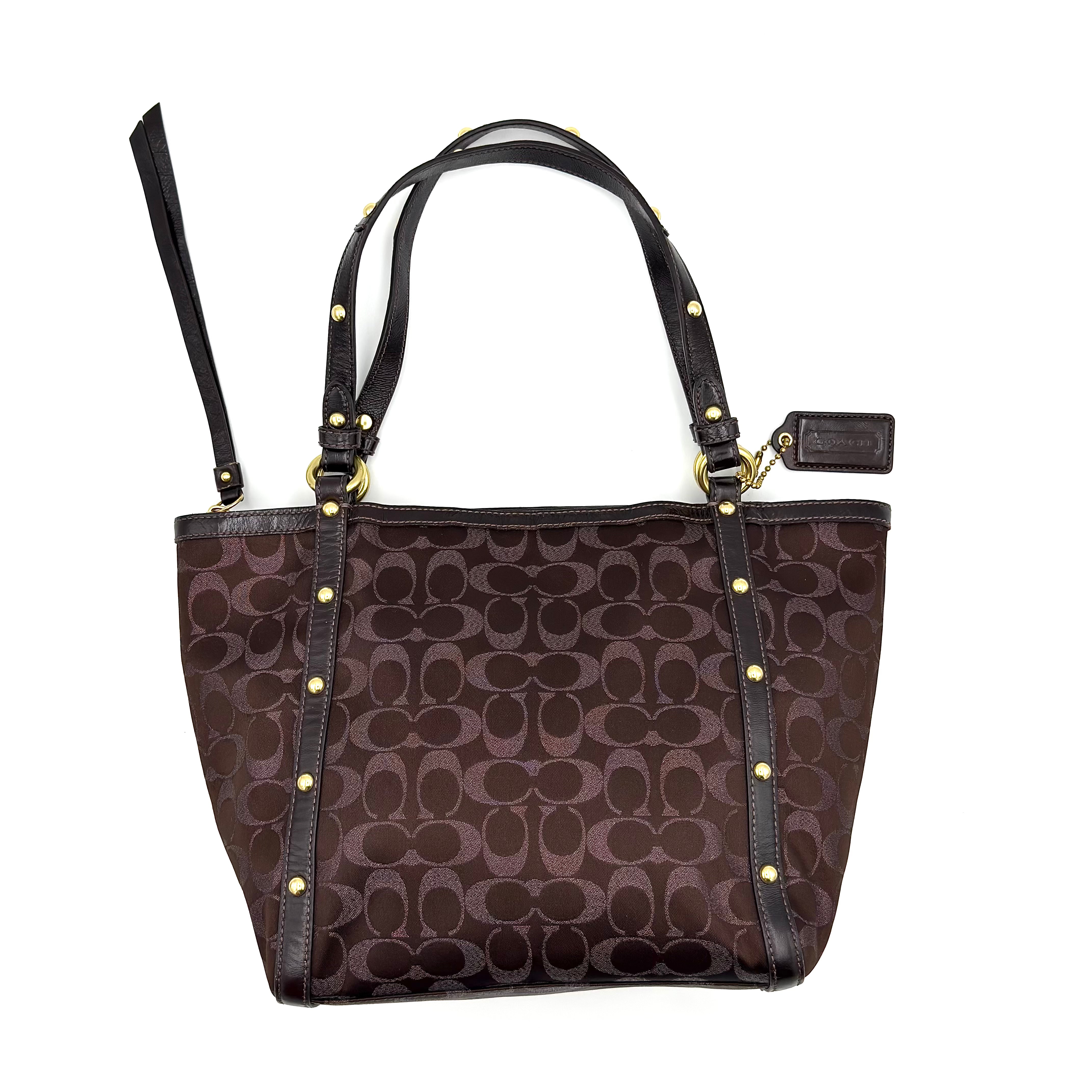 Coach Signature Studded Tote Bag in brown jacquard canvas with gold-tone studs, leather trim, and lavender interior lining.