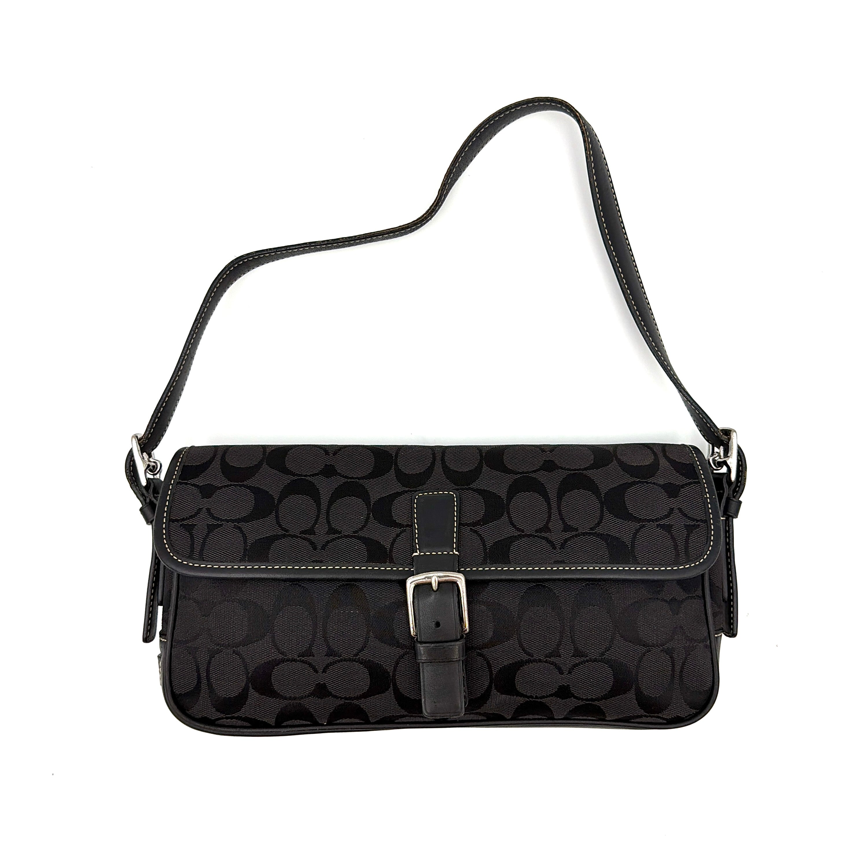Coach Signature Hampton Baguette Shoulder Bag in black with a monogram pattern, featuring a flap closure and adjustable shoulder strap.