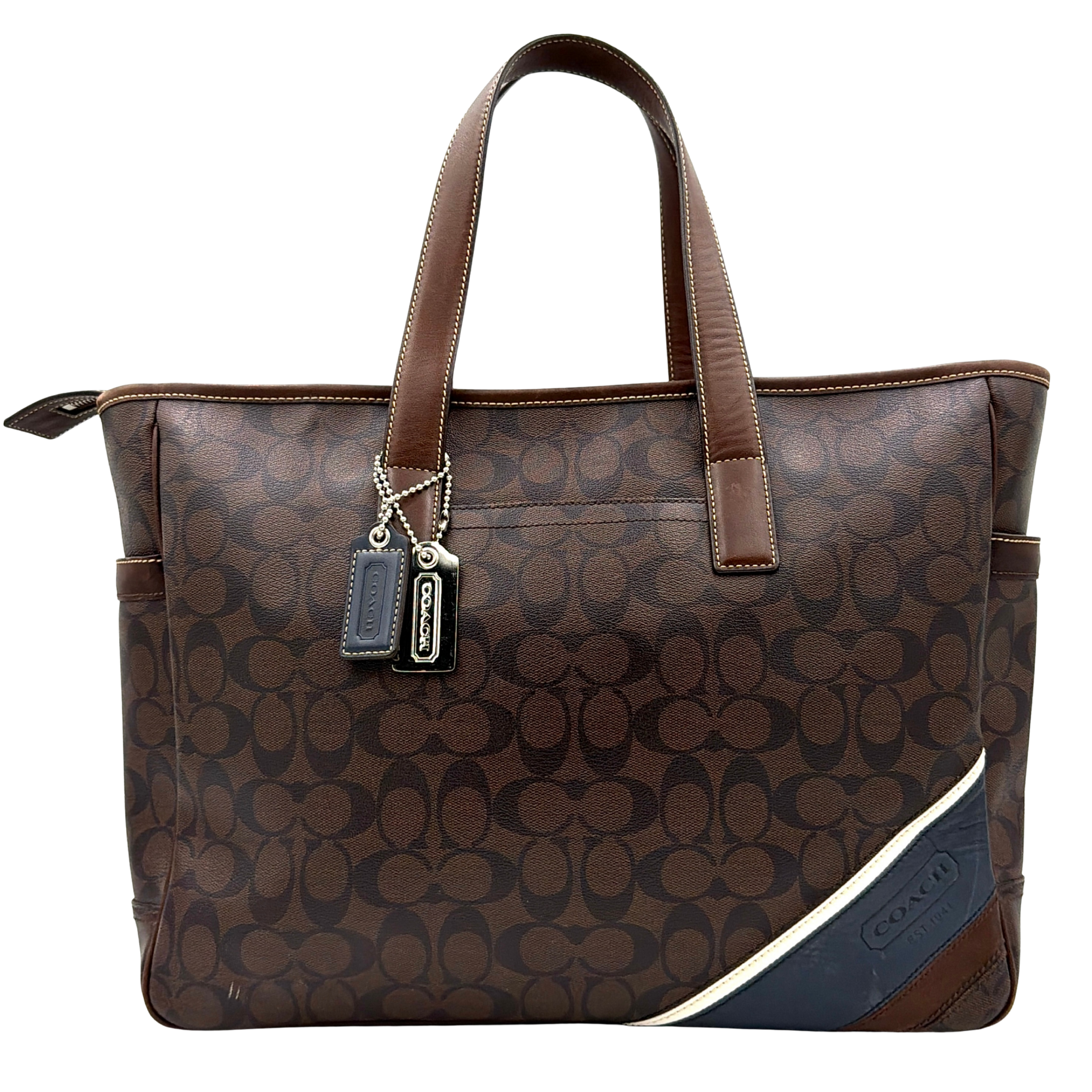 Coach Signature Heritage PVC Tote Bag in brown with signature pattern, dual handles, and spacious design.