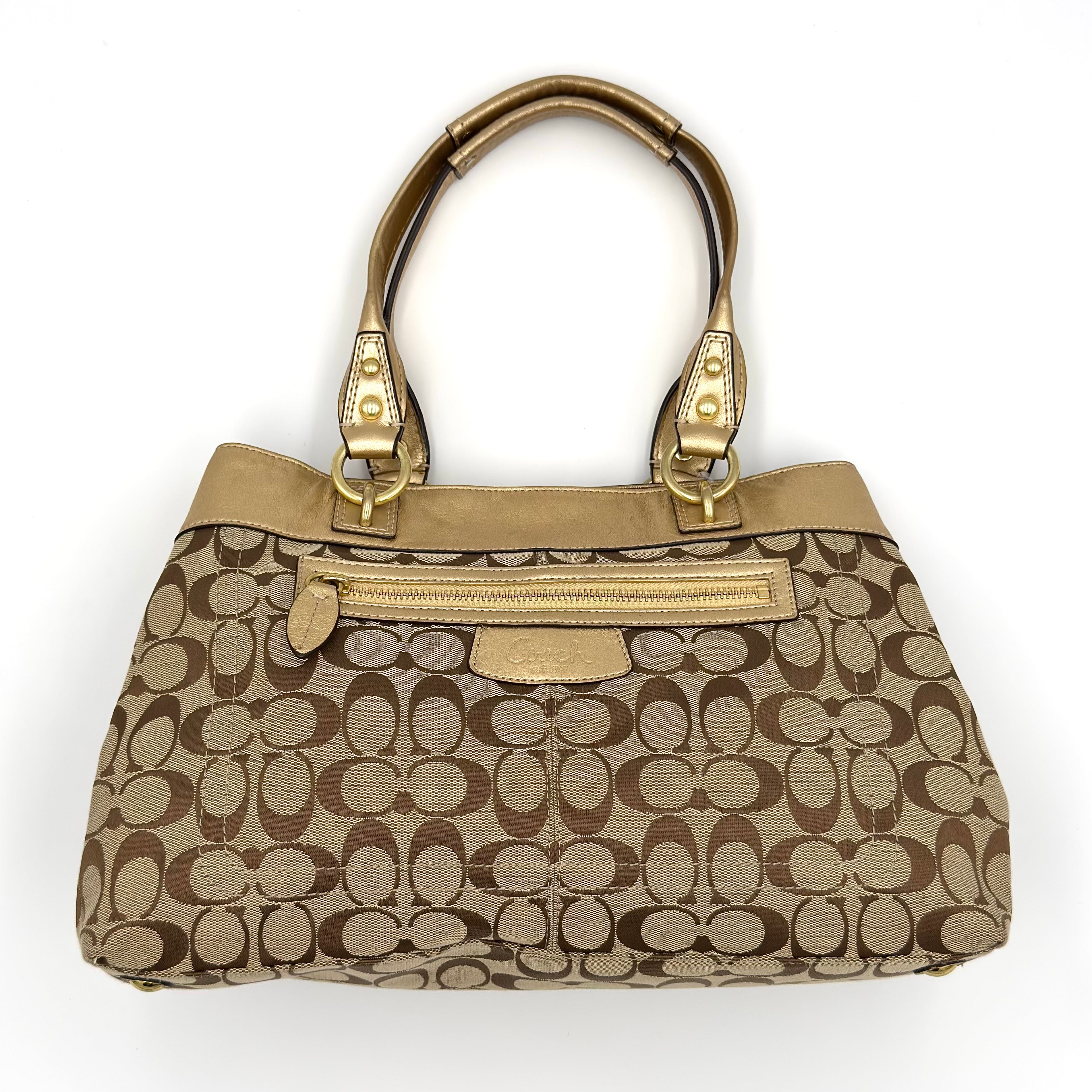 Coach Signature Penelope Shoulder Bag in beige canvas with gold leather trim, gold-tone hardware, exterior zip pocket, and spacious multi-compartment interior.