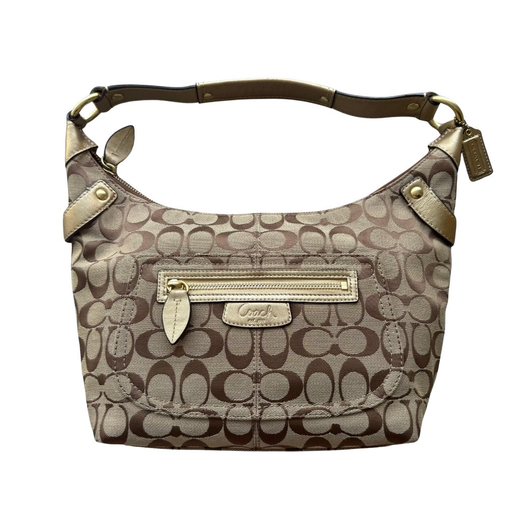 Coach Signature Penelope shoulder bag in beige jacquard featuring metallic gold leather trim, front zip pocket, adjustable shoulder strap, and top zip closure.