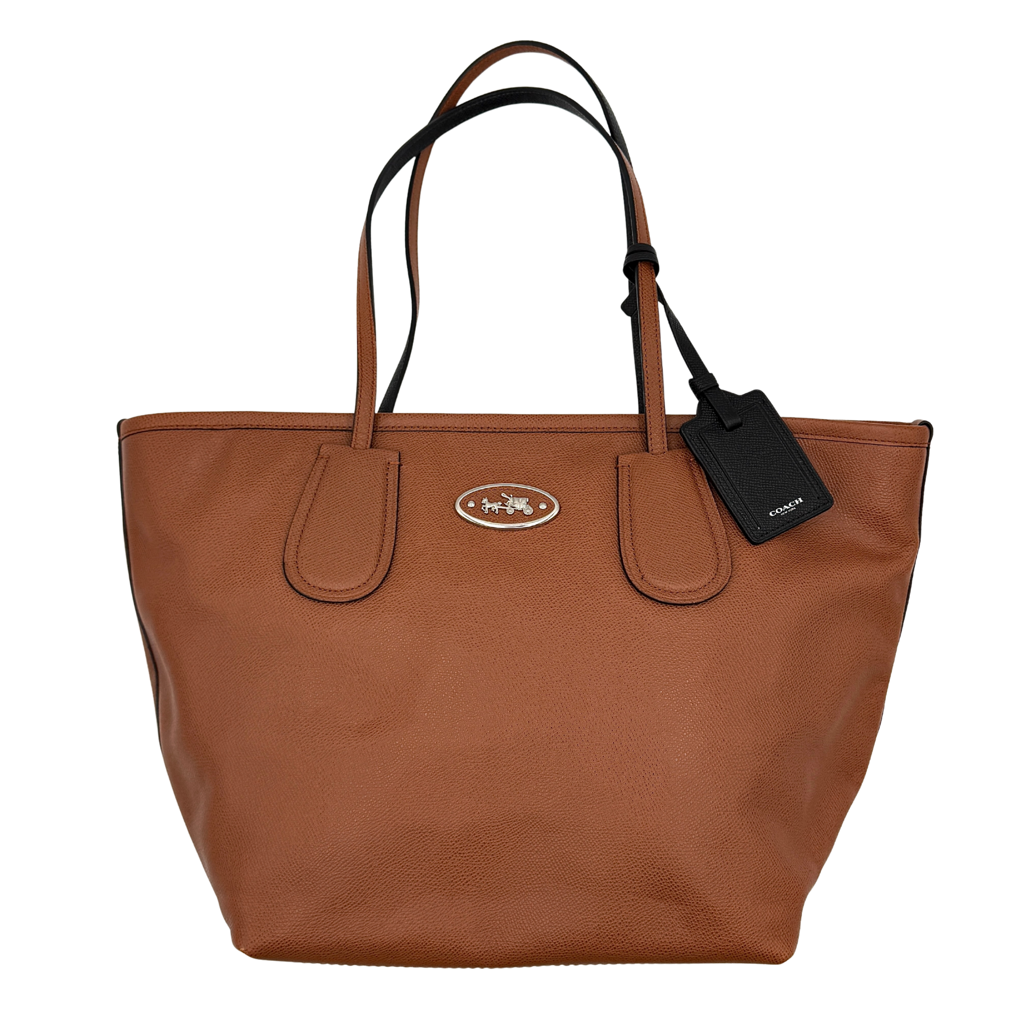 Coach Taxi City tote bag in brown pebbled leather featuring a structured silhouette, dual shoulder straps, Coach oval logo plaque, and hanging tag.