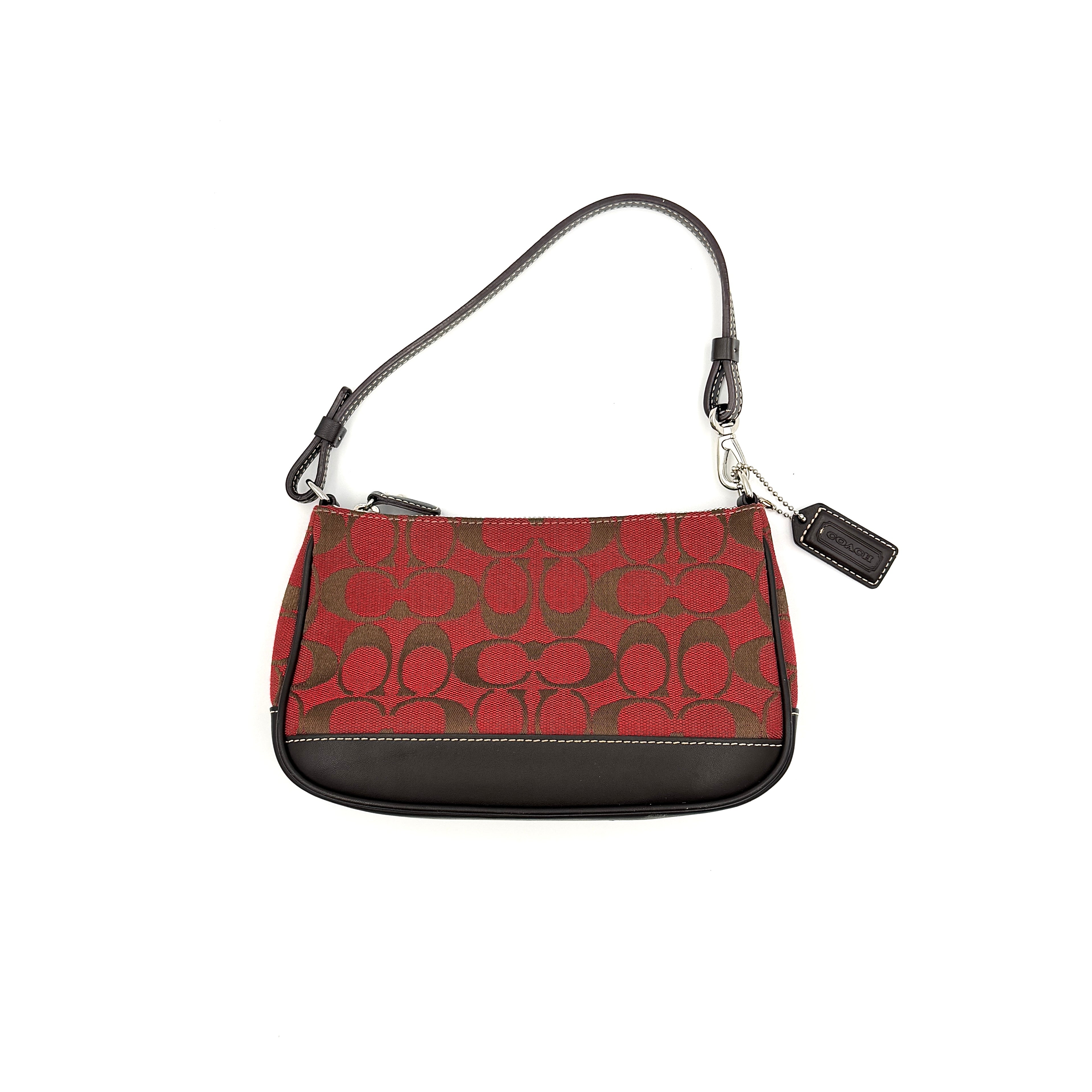 Coach Y2K Demi Shoulder Bag in red and brown signature canvas with dark leather trim, featuring a compact silhouette and zip-top closure.
