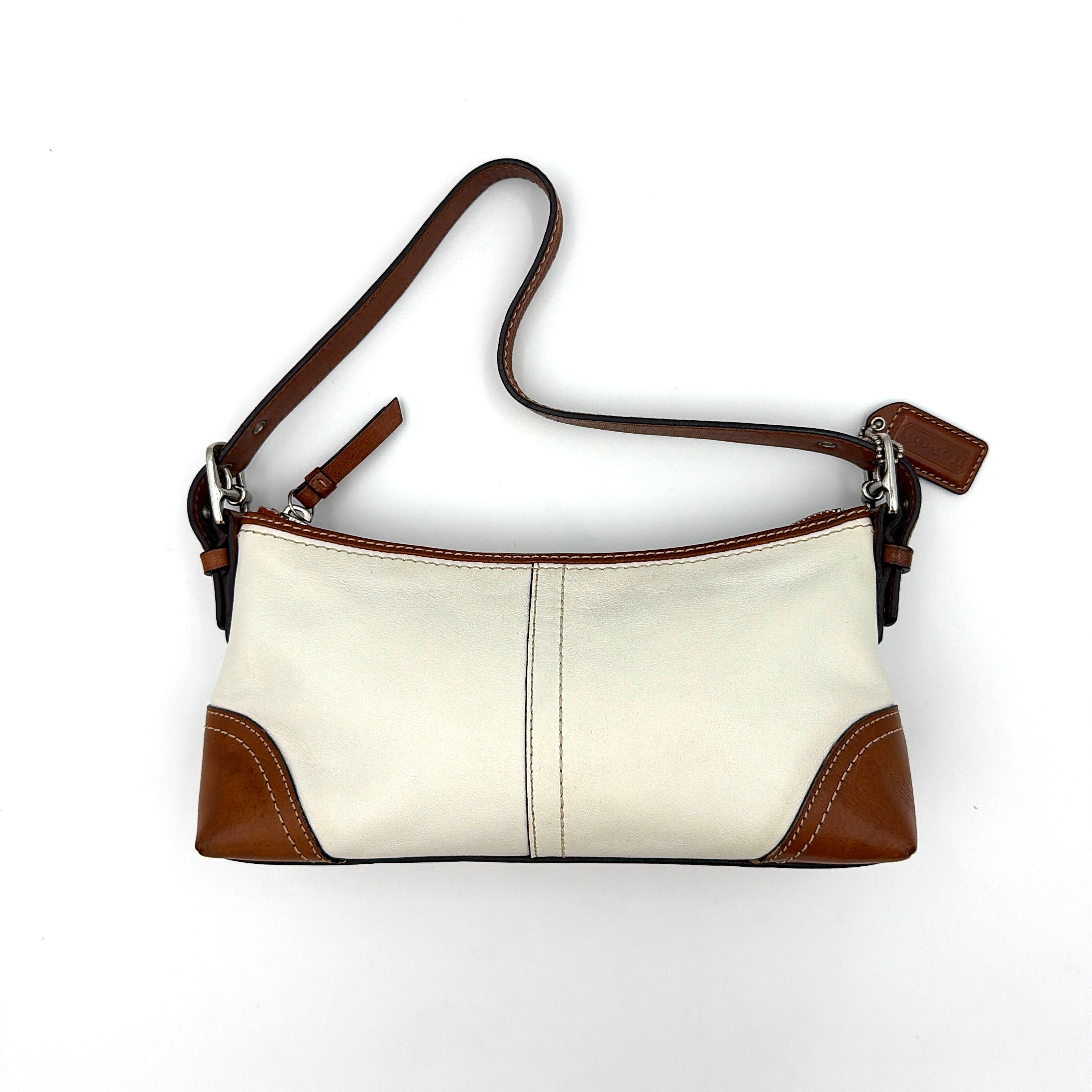 Coach cream and tan Hampton Demi Baguette shoulder bag with leather trim, featuring a zip closure and single strap