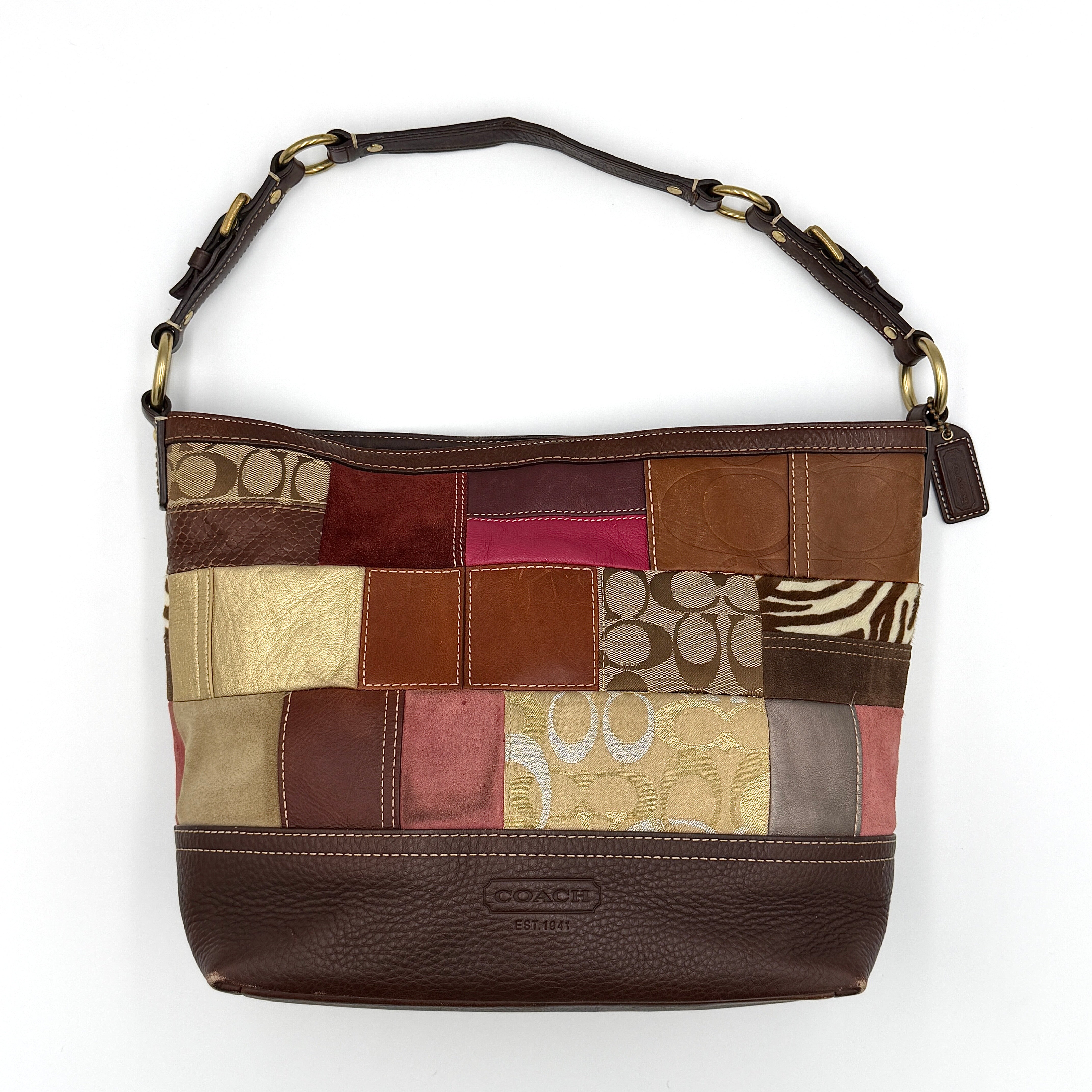 Coach Y2K Holiday patchwork shoulder bag in multicolor featuring mixed patterned panels, grid layout design, and short shoulder strap