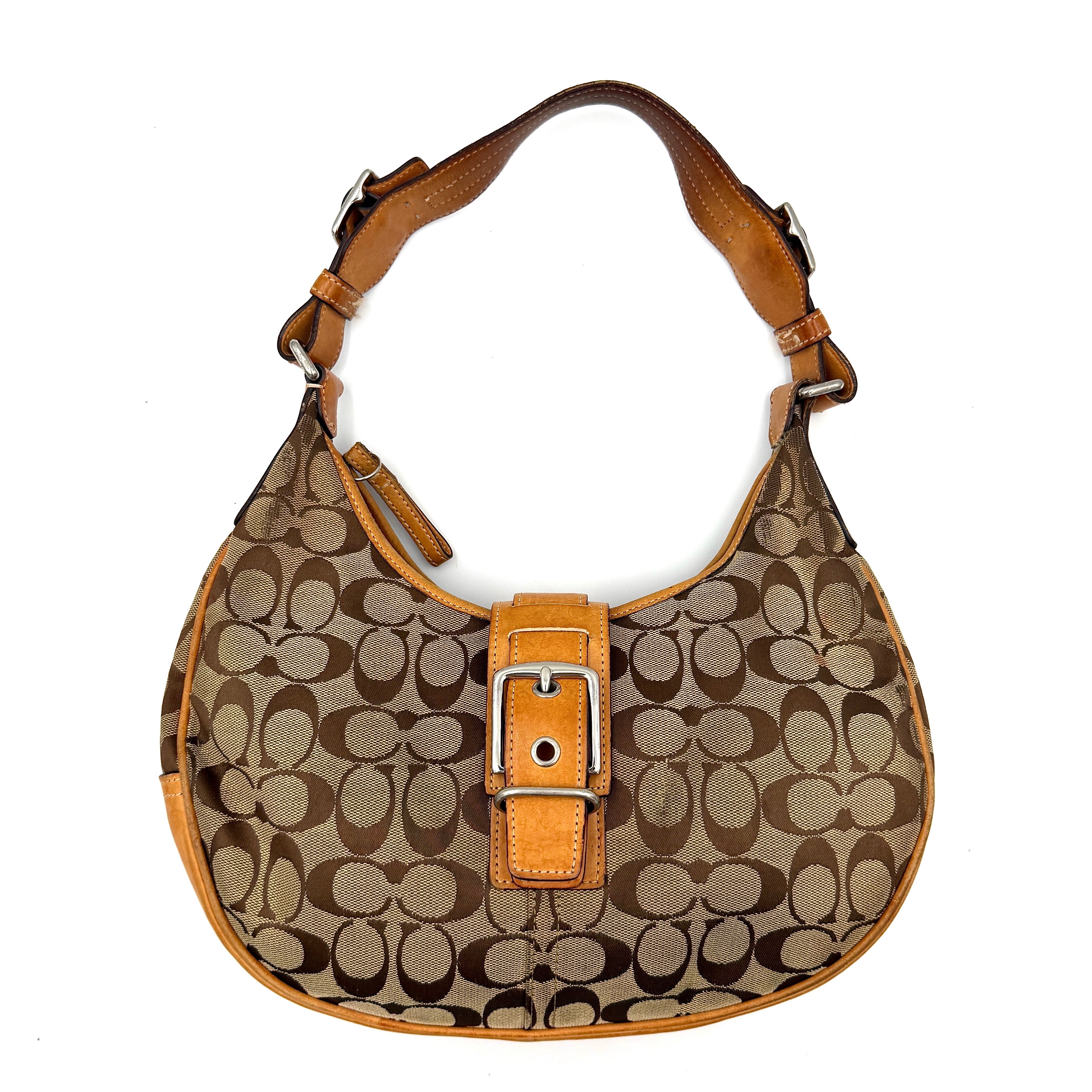 Coach Y2K Signature Hobo Shoulder Bag in beige and tan, featuring a prominent buckle detail and signature pattern.