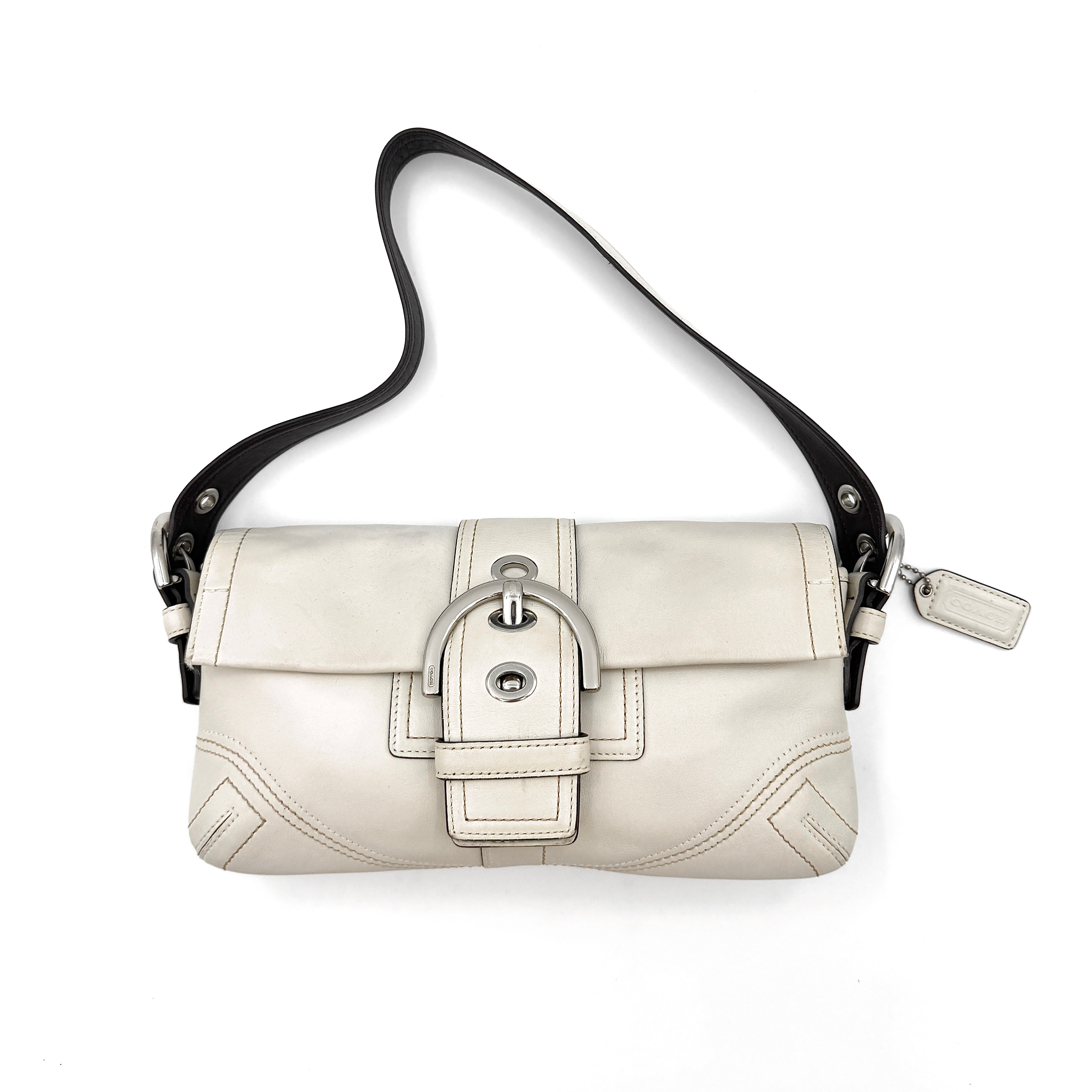 Coach Y2K Soho Buckle Shoulder Bag in ivory with a sleek design, distinctive buckle closure, and black strap
