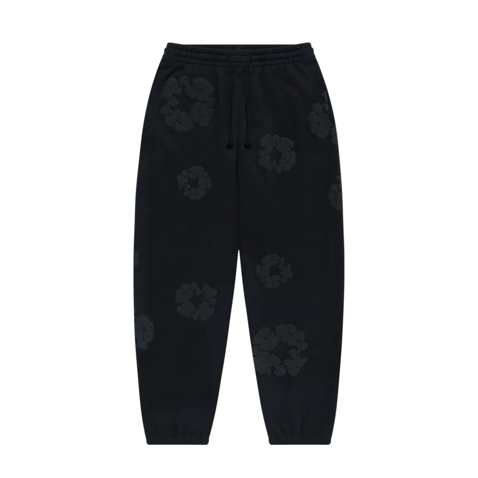 Denim Tears black sweatpants featuring a mono cotton wreath pattern, with elastic waistband and cuffed hems.