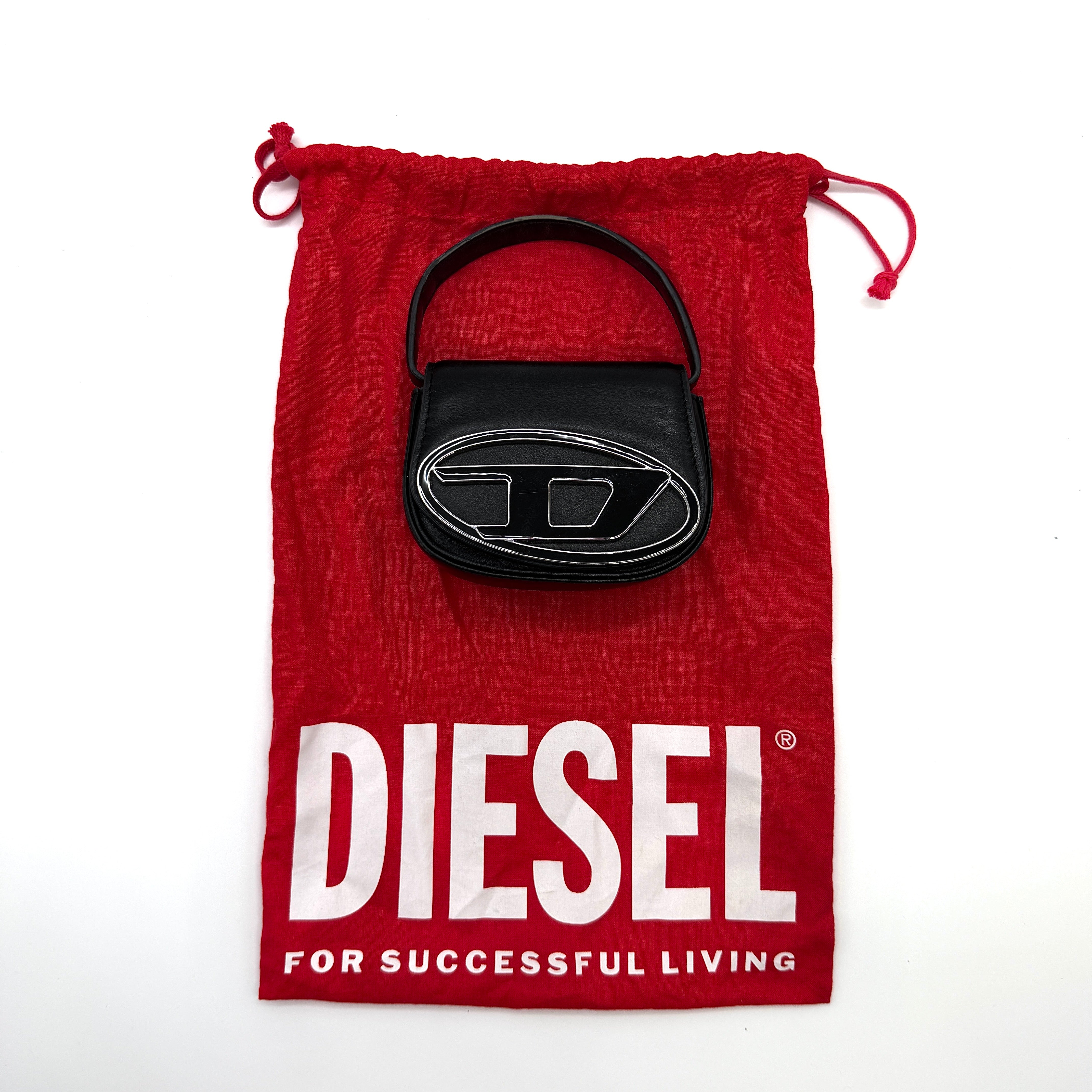 Diesel 1DR-XS Mini Bag Black, crafted from smooth black leather with a silver-tone oversized 1DR logo plate and curved top handle.