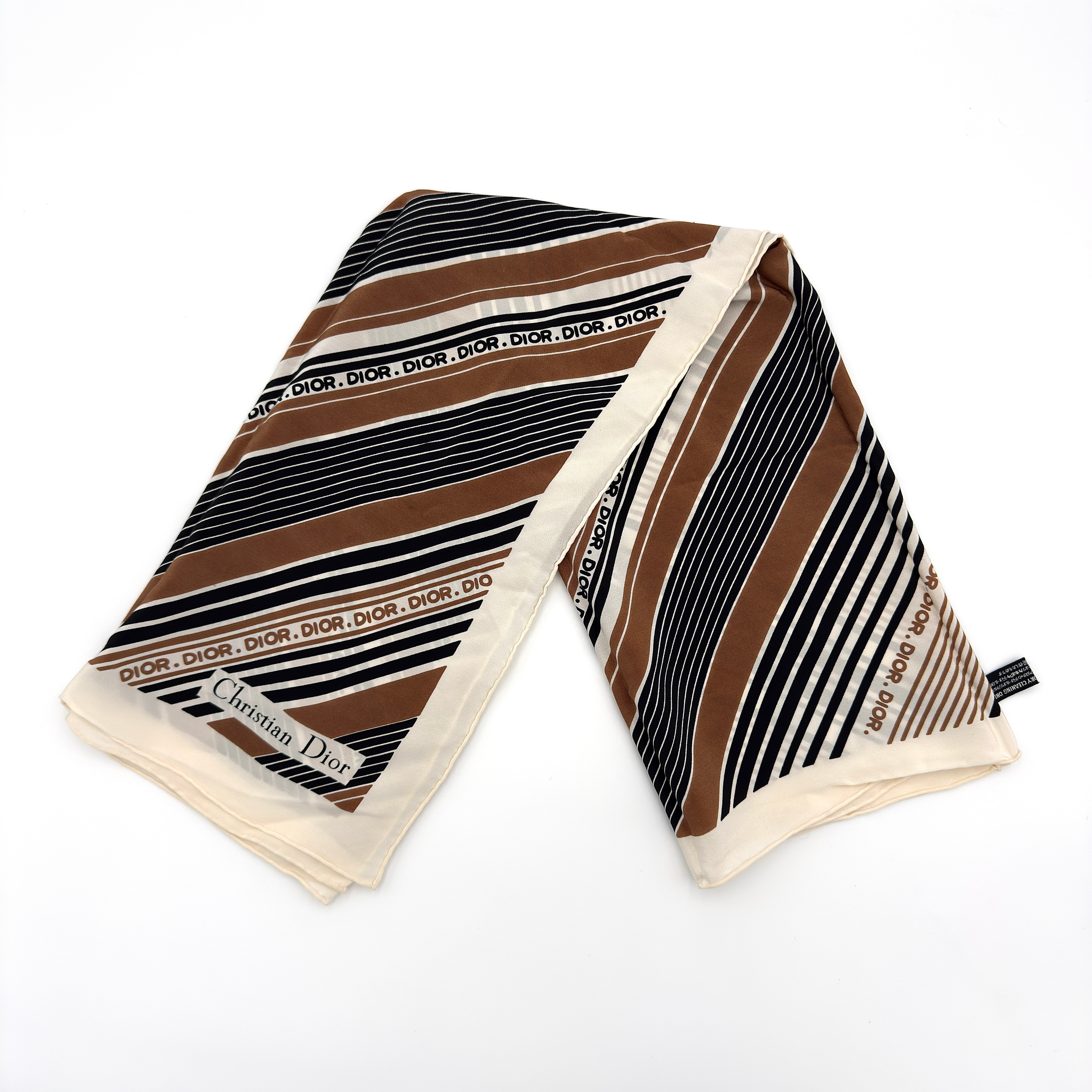Dior Stripe Silk Scarf Multicolor, crafted from lightweight silk with diagonal brown, black, and ivory stripe pattern and repeating Dior logo.