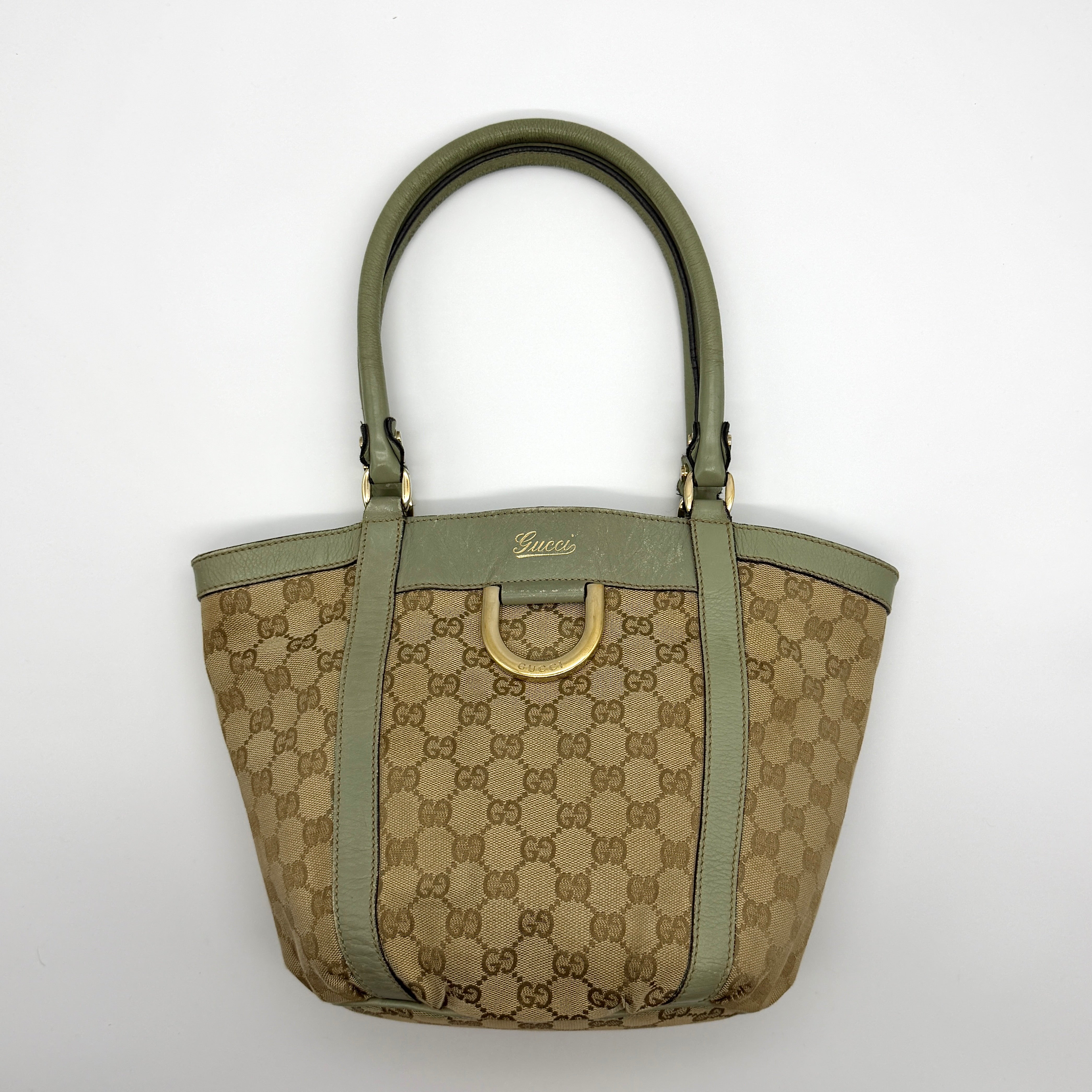 Gucci GG Monogram Abbey D-Ring Shoulder Bag in Beige and Green, featuring GG canvas with gold-tone hardware and green leather trim.