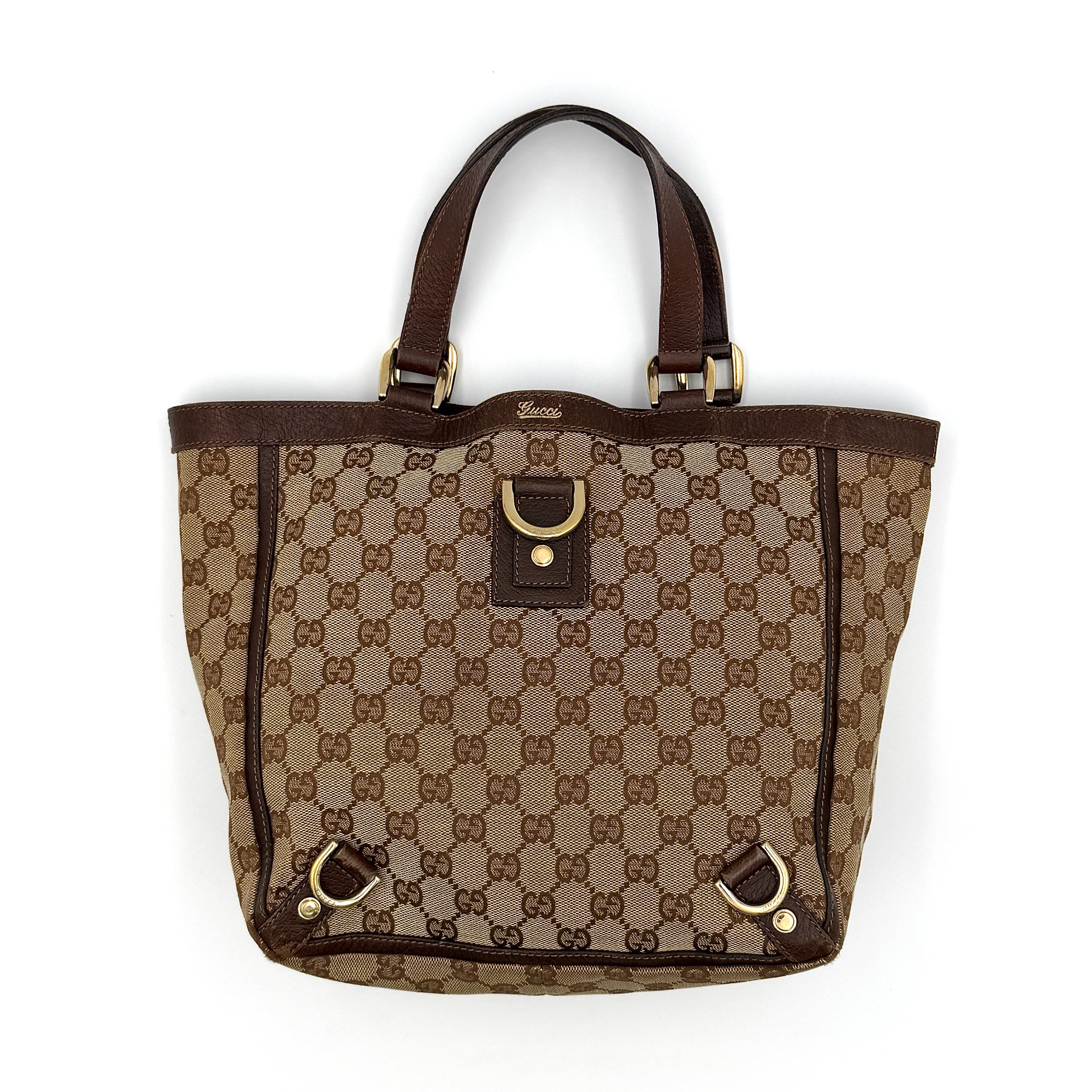 Gucci GG monogram Abbey D-ring tote bag in beige canvas with brown leather trim and gold-tone hardware.
