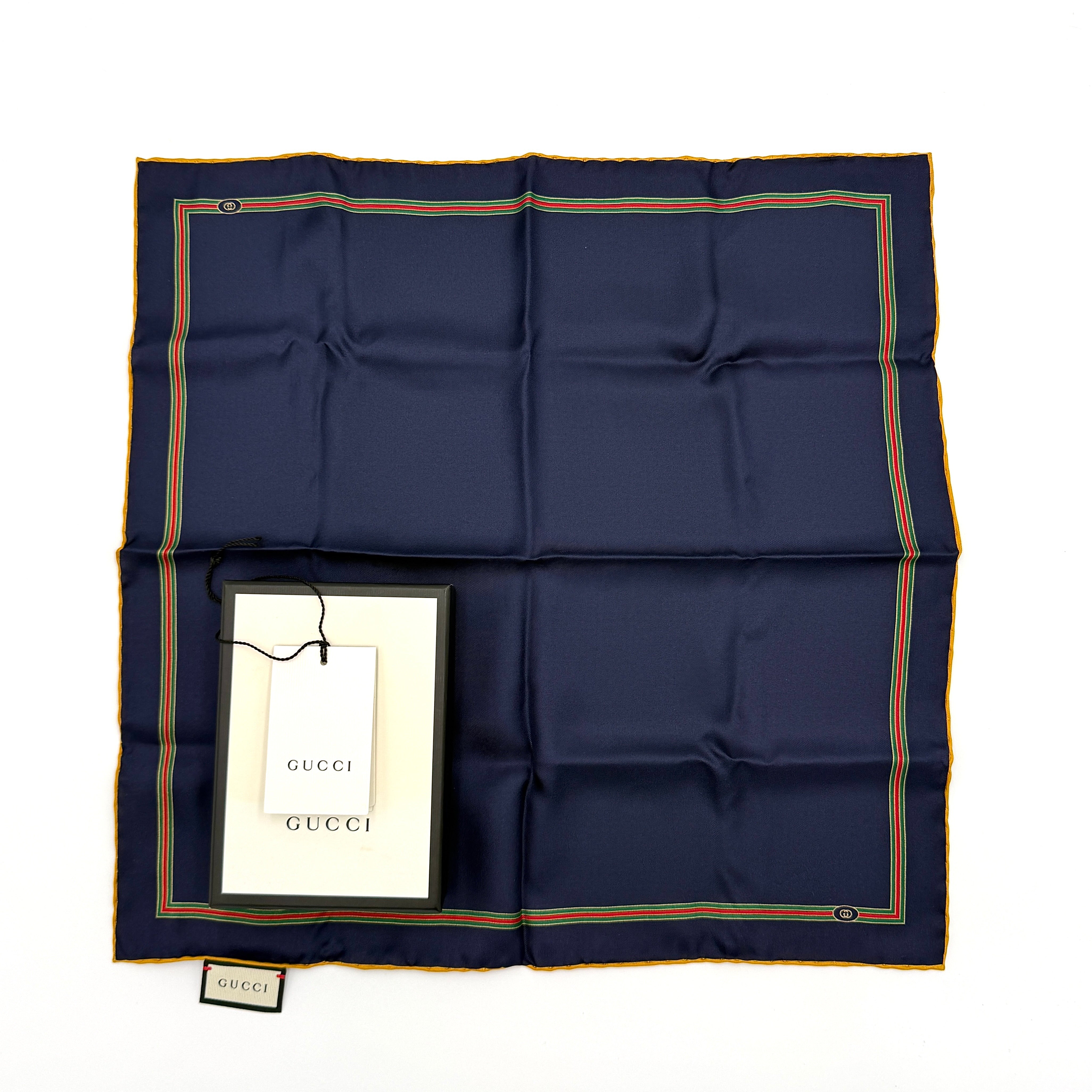 Gucci navy blue silk scarf with web pattern along the edges, displayed flat with label and box.