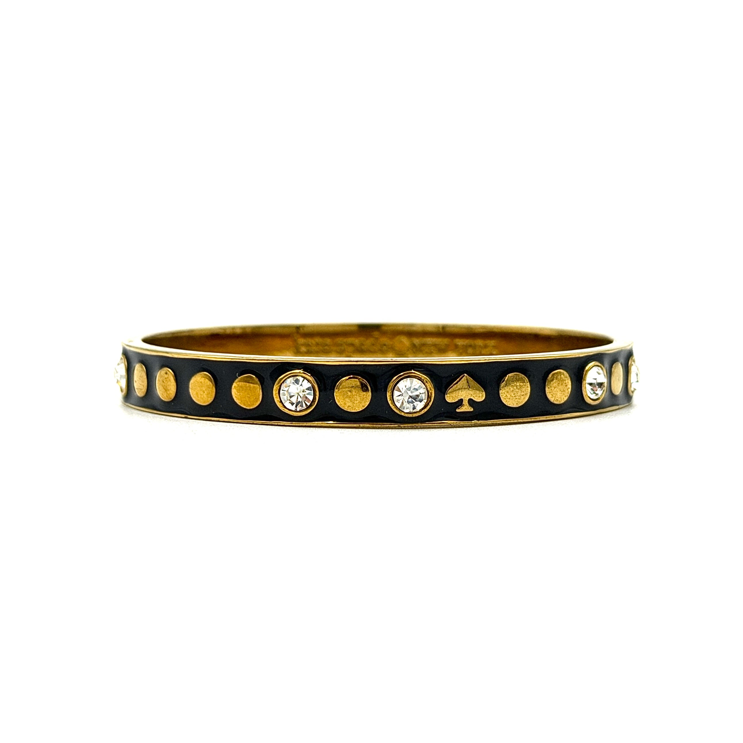 Kate Spade Spot the Spade bangle bracelet in black and gold featuring enamel finish, spade motifs, and crystal accents.
