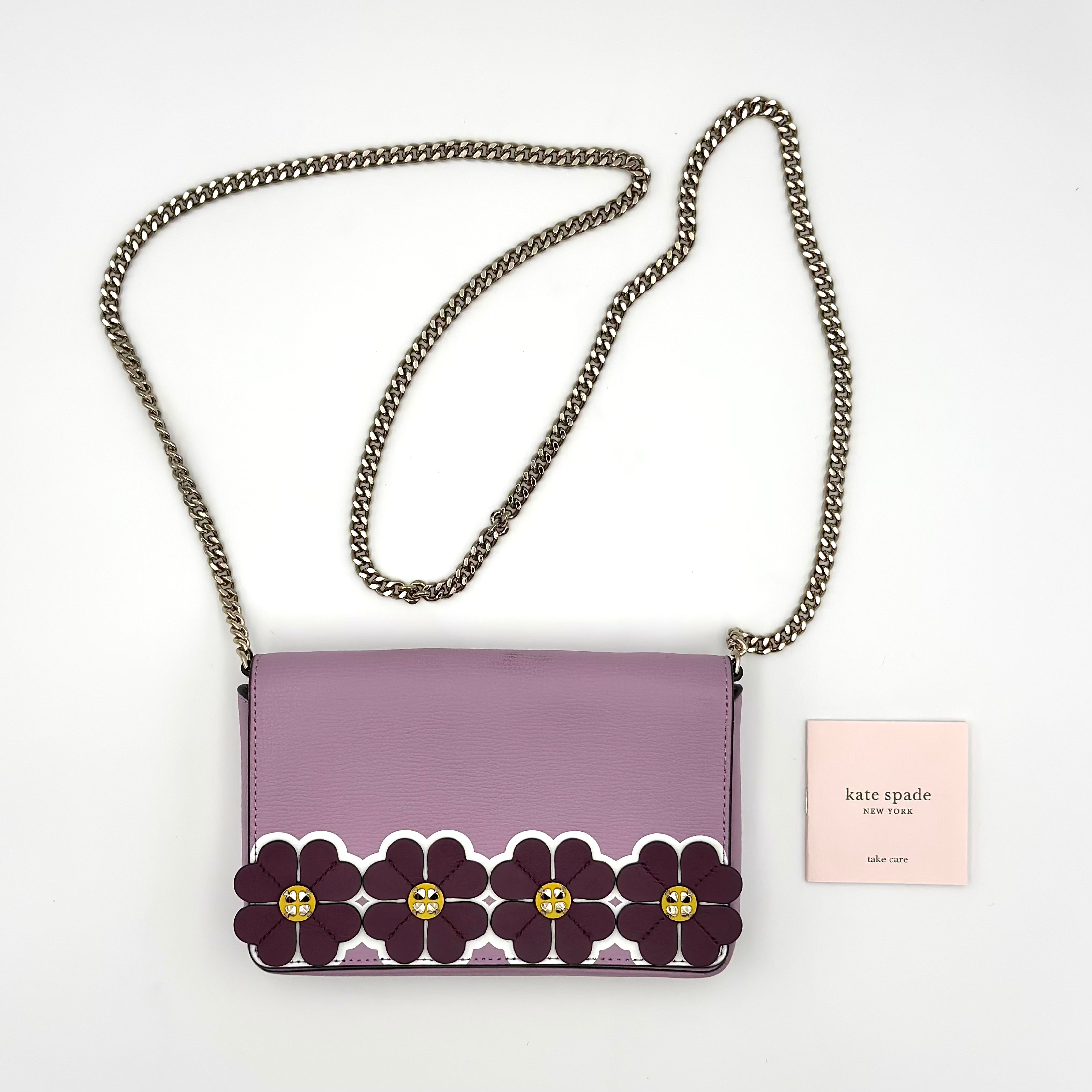 Kate Spade Sylvia Graphic Clover Appliqué Crossbody Bag in purple leather with floral appliqué, gold-tone hardware, and official card included.