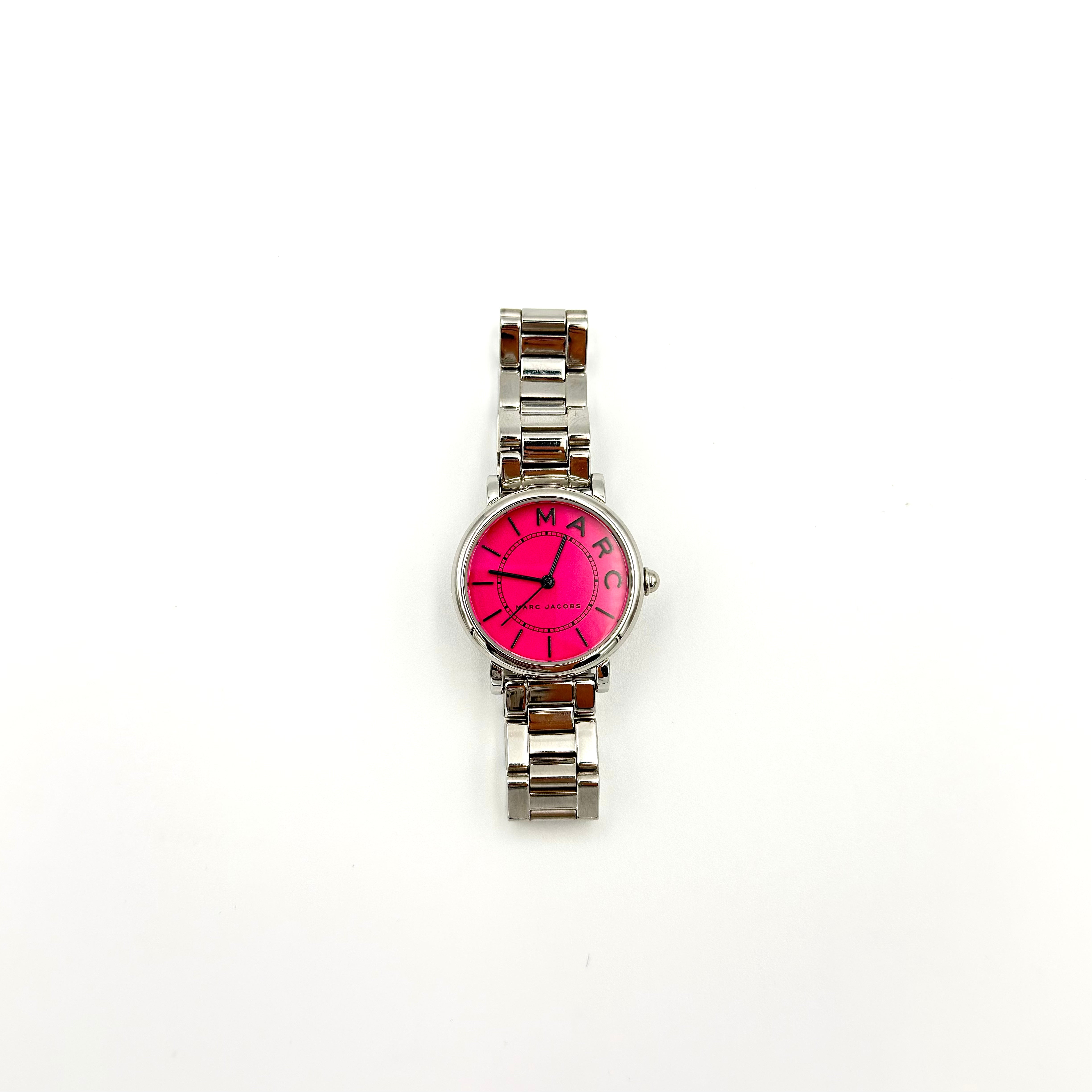 Marc Jacobs Roxy stainless steel watch with vibrant fuchsia dial, silver-tone bracelet, and minimalist hour markers.