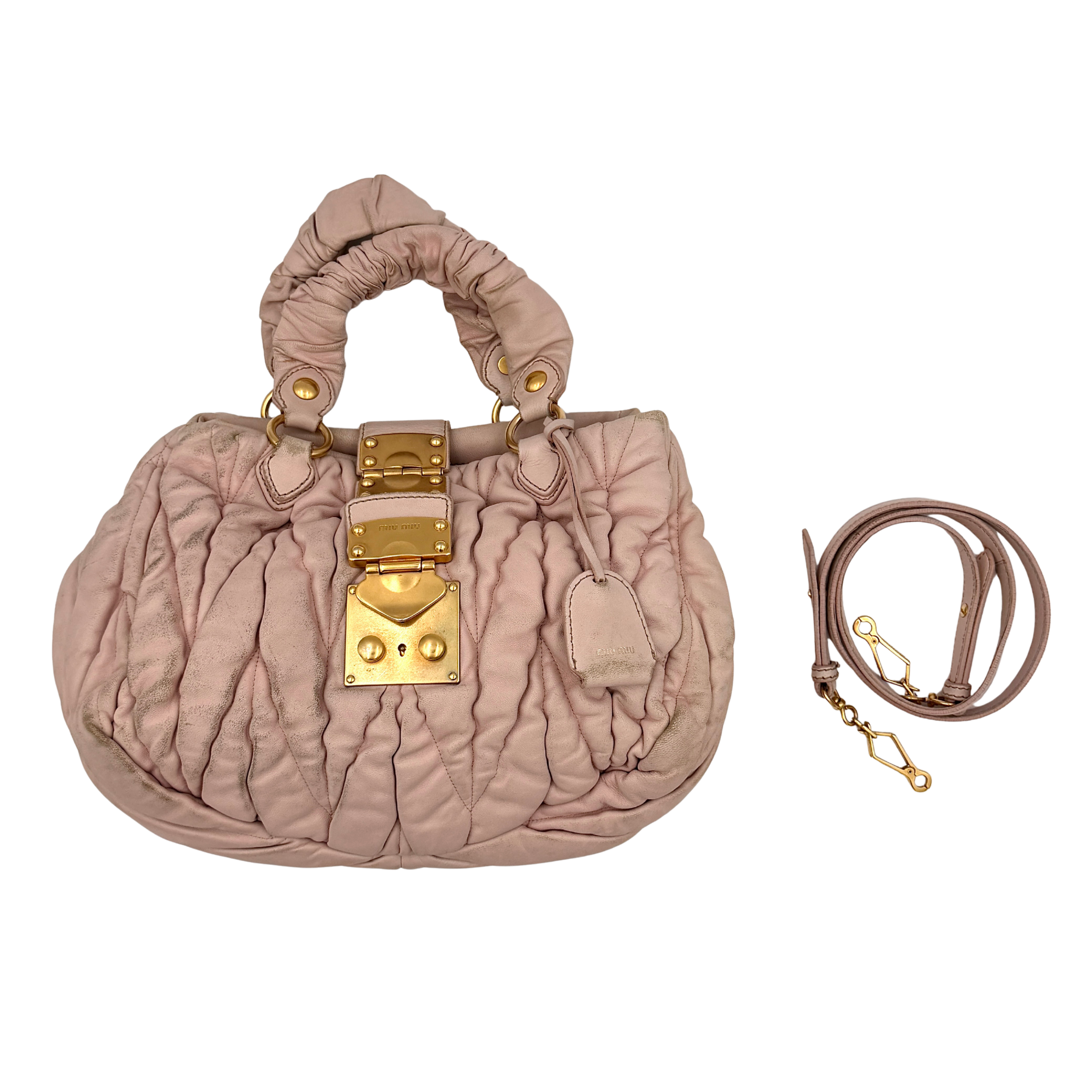 Miu Miu pink matelassé shoulder bag with gold-tone hardware and a detachable strap showcasing versatile carrying options
