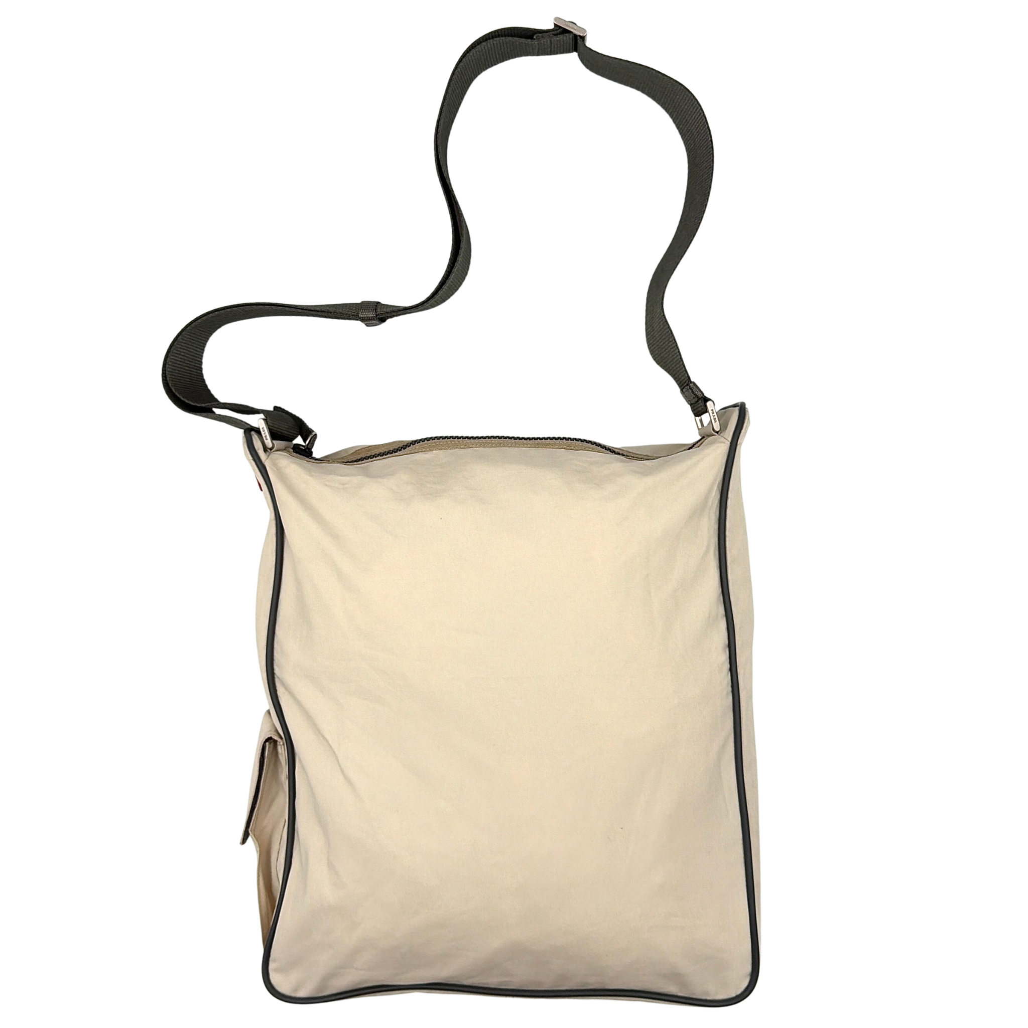 Prada Sport crossbody bag in cream with black trim featuring a red Prada Sport logo detail and adjustable shoulder strap.