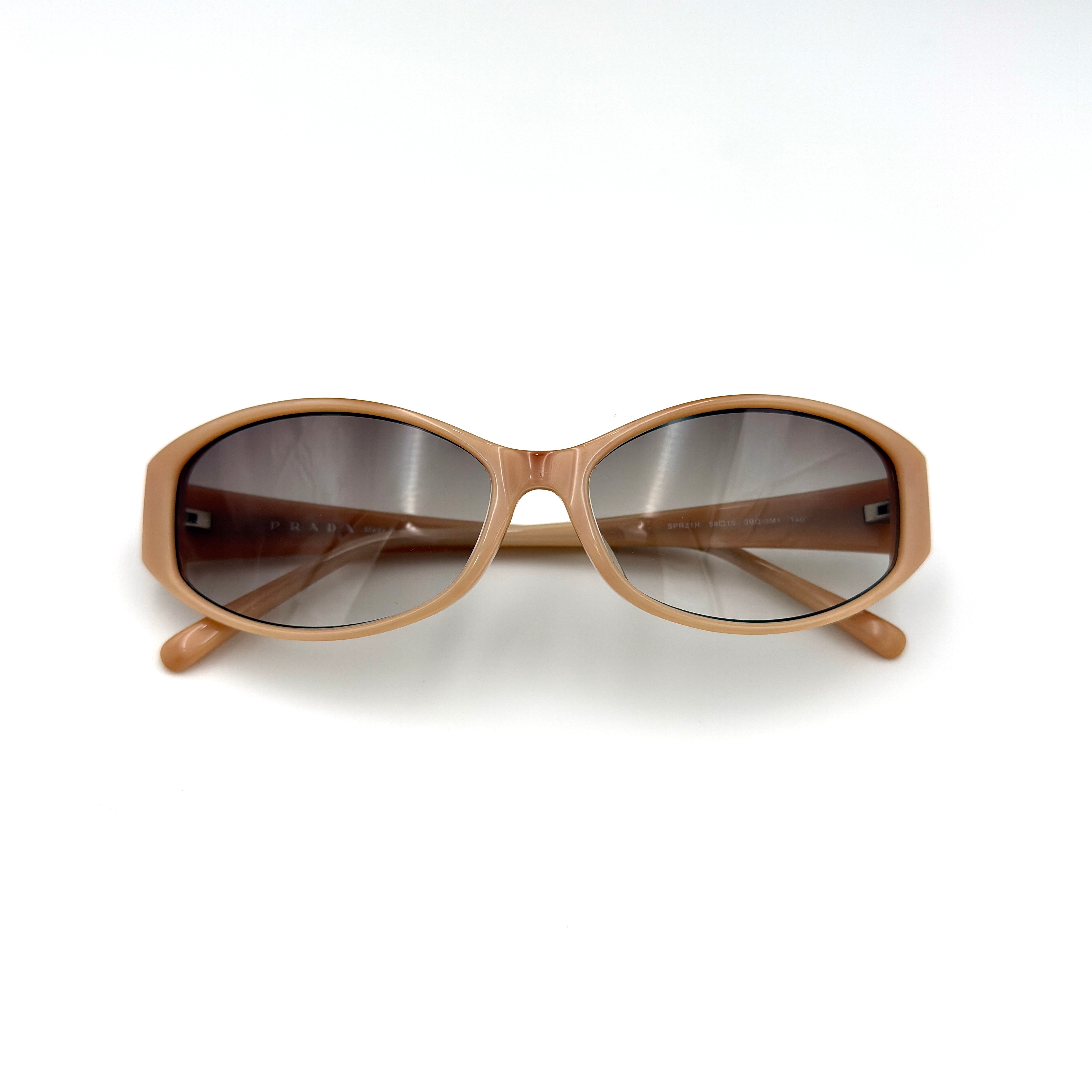 Prada SPR21H Sunglasses in beige acetate with gradient lenses and Prada metal logo temples.