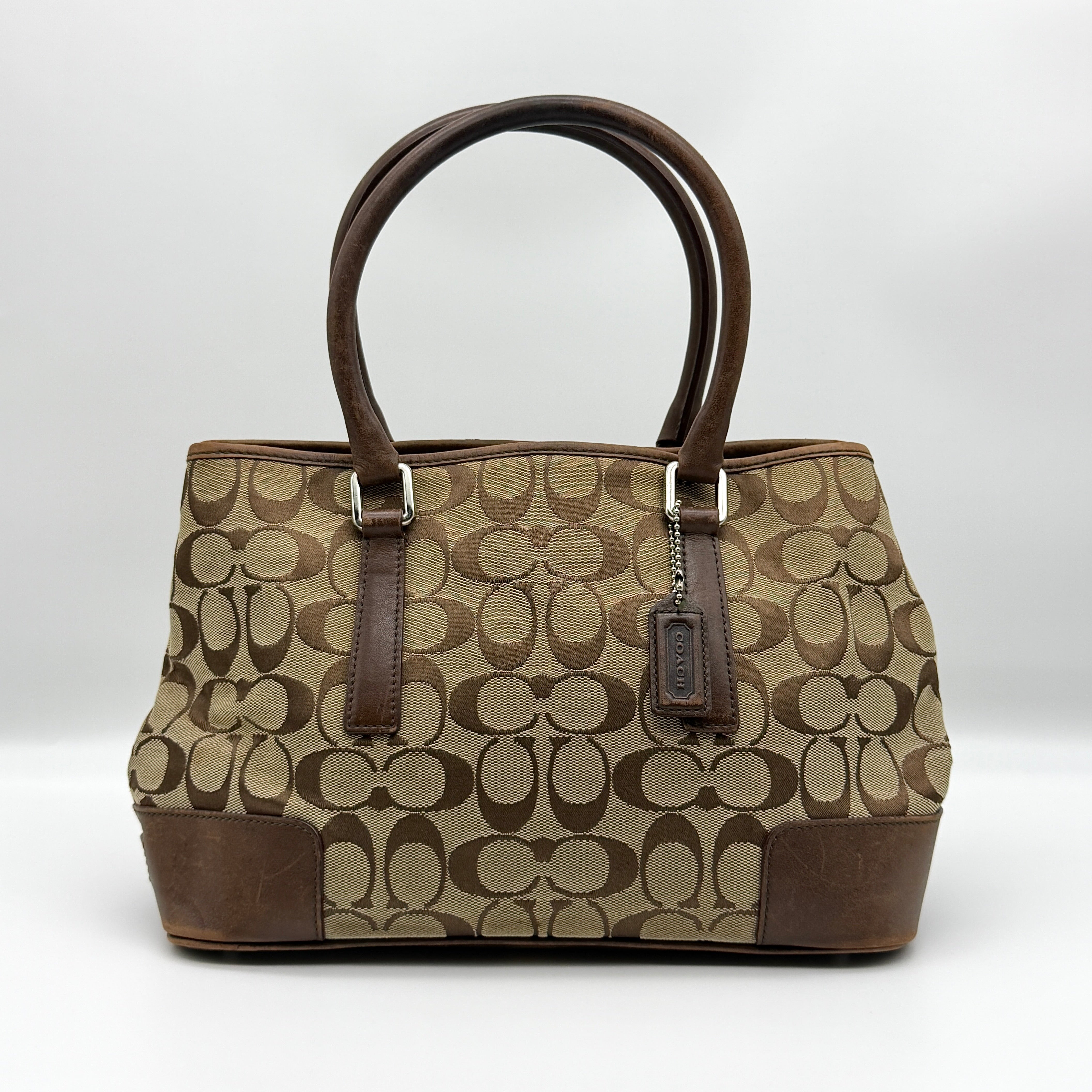 Coach Signature Canvas Handbag in brown and beige monogram with leather trim and orange interior