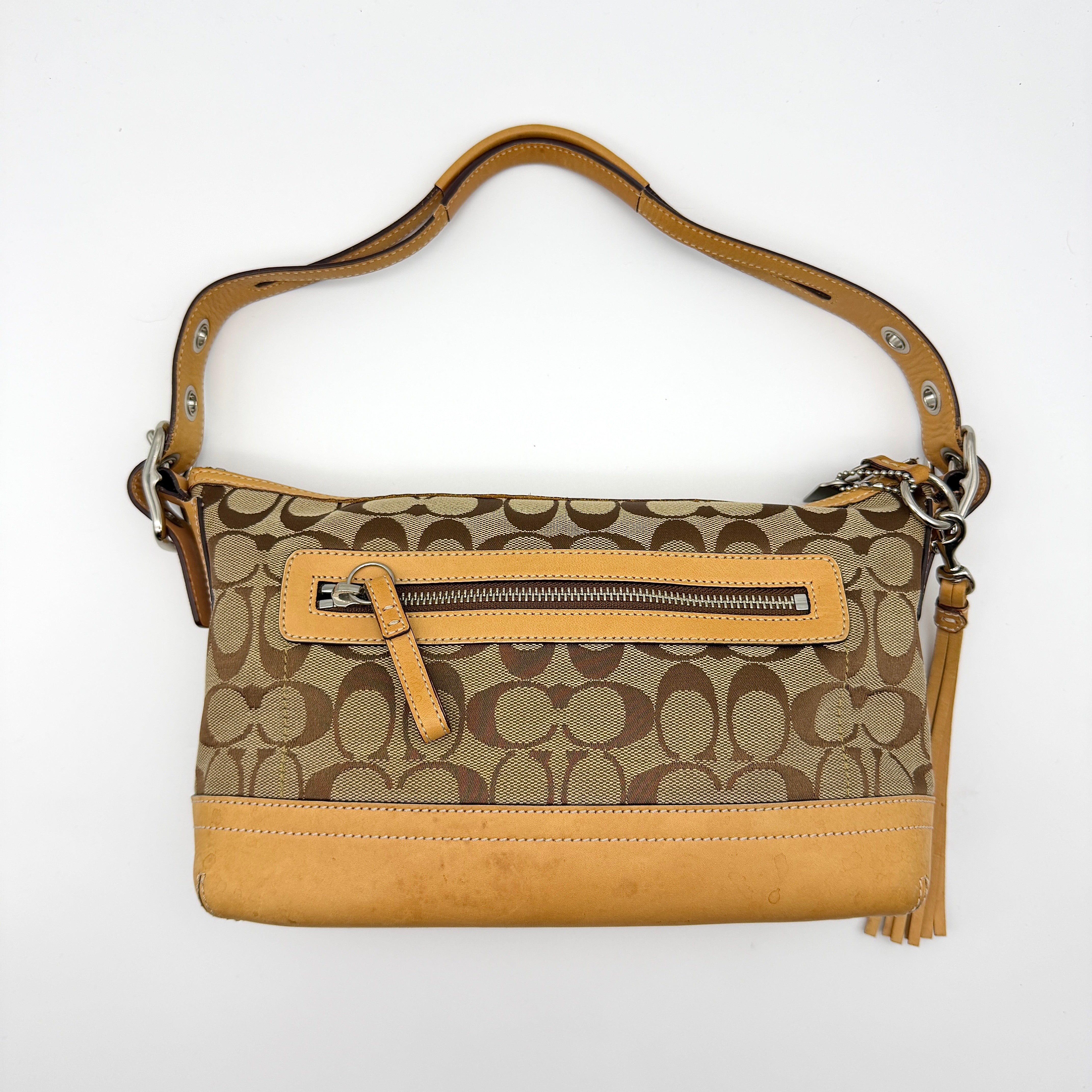 Coach Signature East West Shoulder Bag in beige jacquard monogram canvas with light tan leather trim and tassel detail
