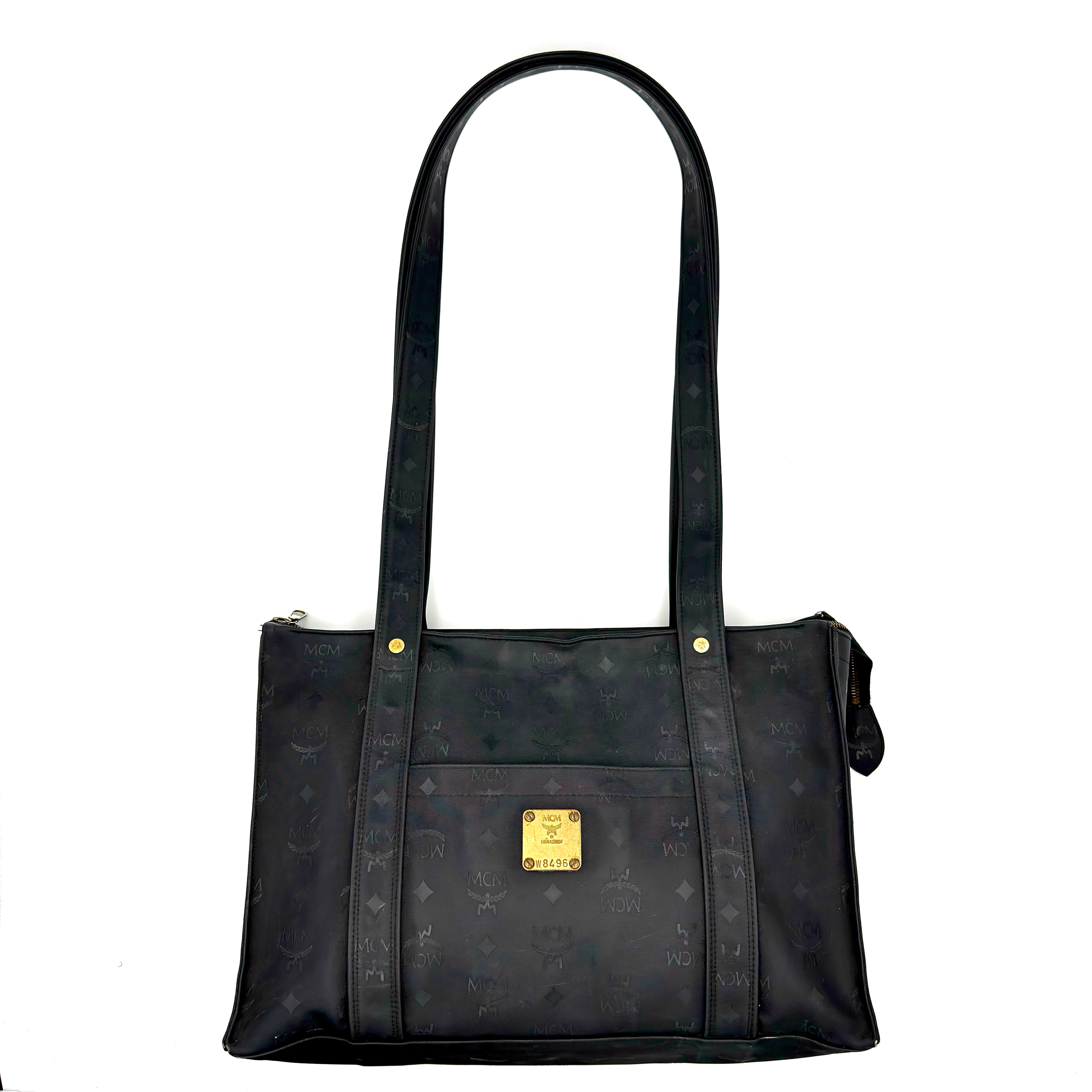 MCM Visetos Monogram Nylon Tote Bag in black with gold-tone logo plaque and dual leather straps