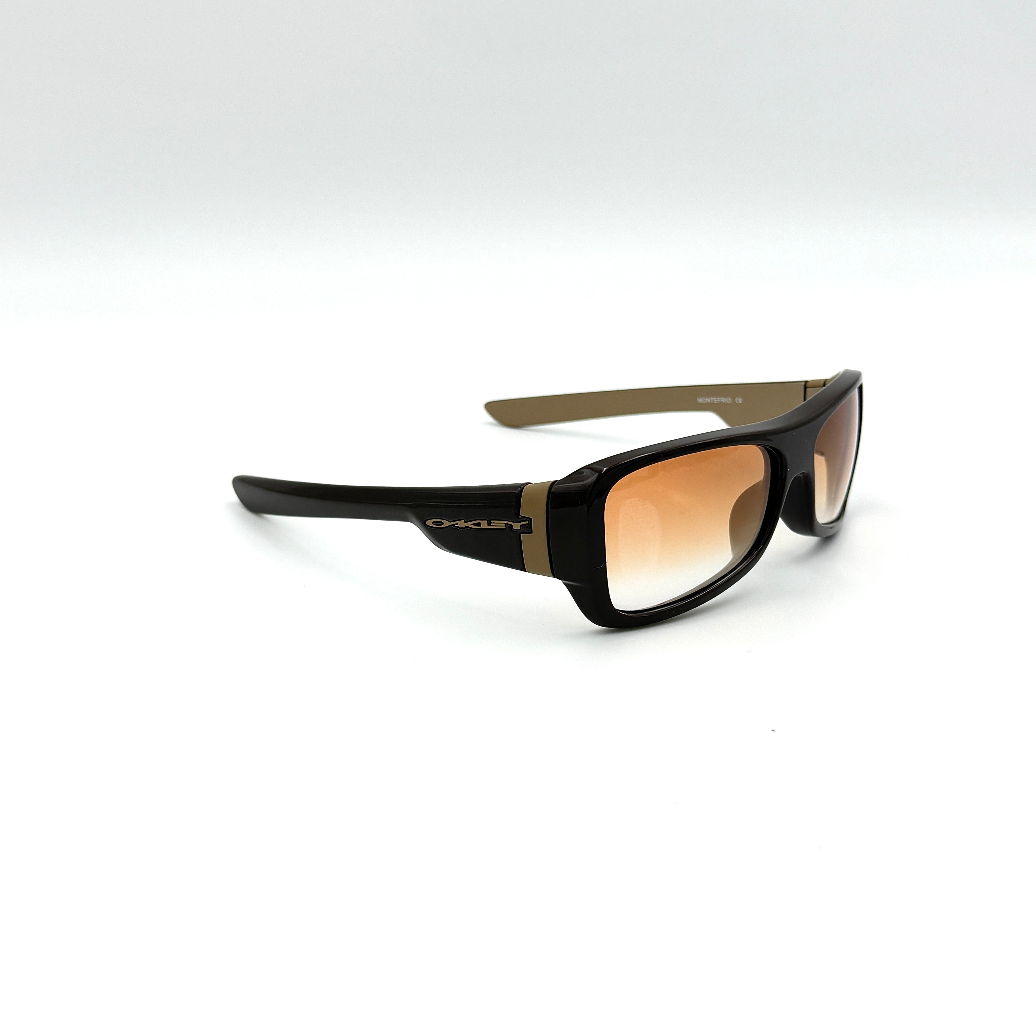 Oakley Motefrio Sunglasses in brown with bronze gradient lenses and gold-tone Oakley logo detailing.