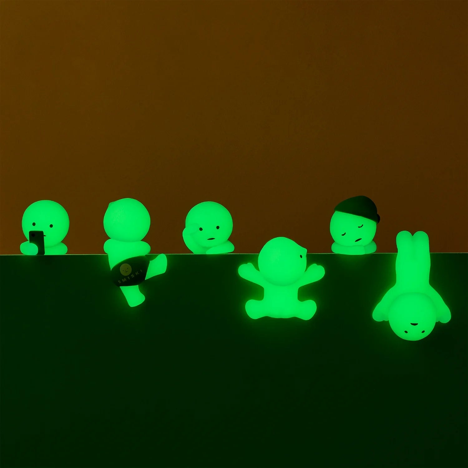Smiski collectible figure, glow-in-the-dark mini character in quirky poses, perfect for shelves and desks.