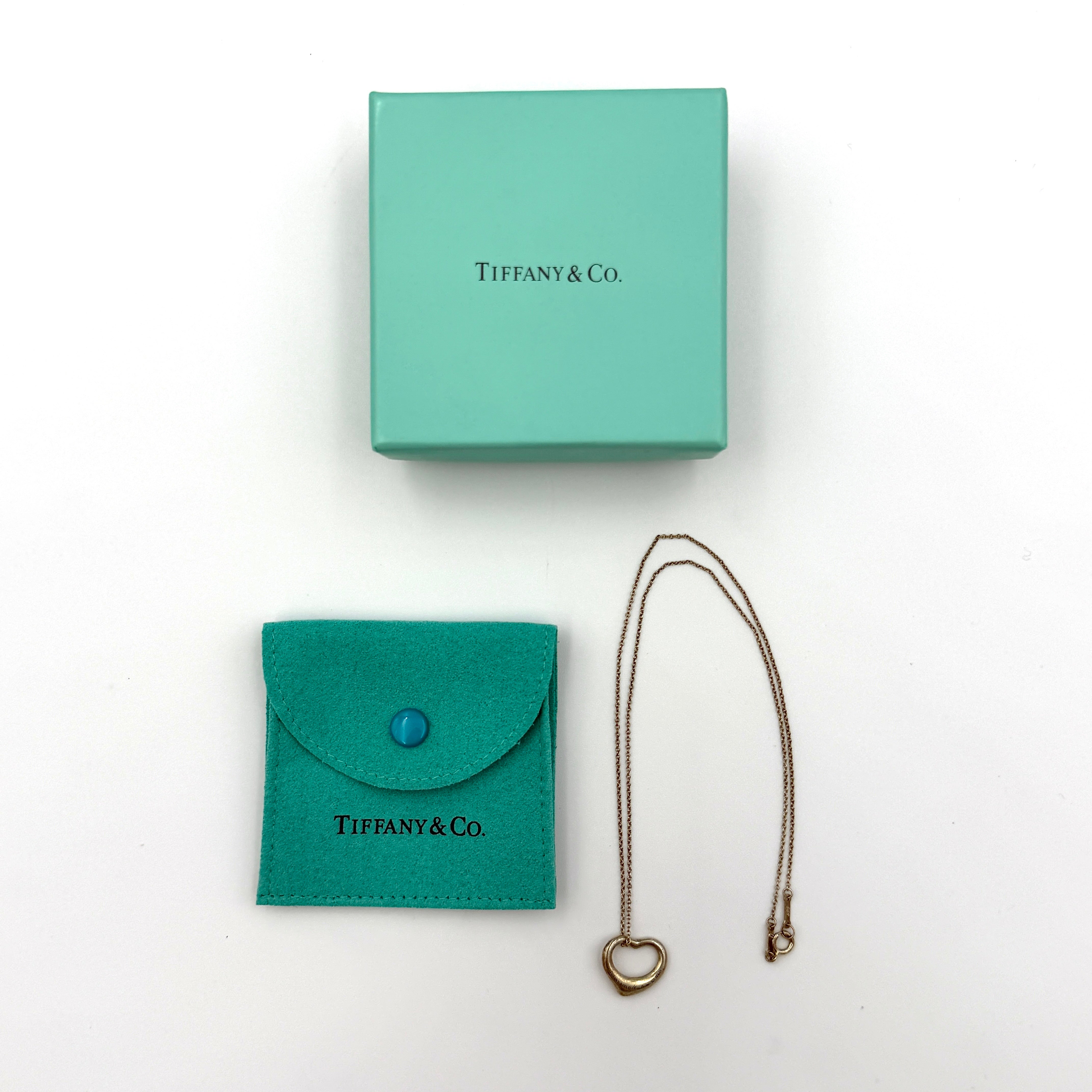 Tiffany & Co. Elsa Peretti open heart necklace in silver featuring iconic heart pendant on fine chain.
